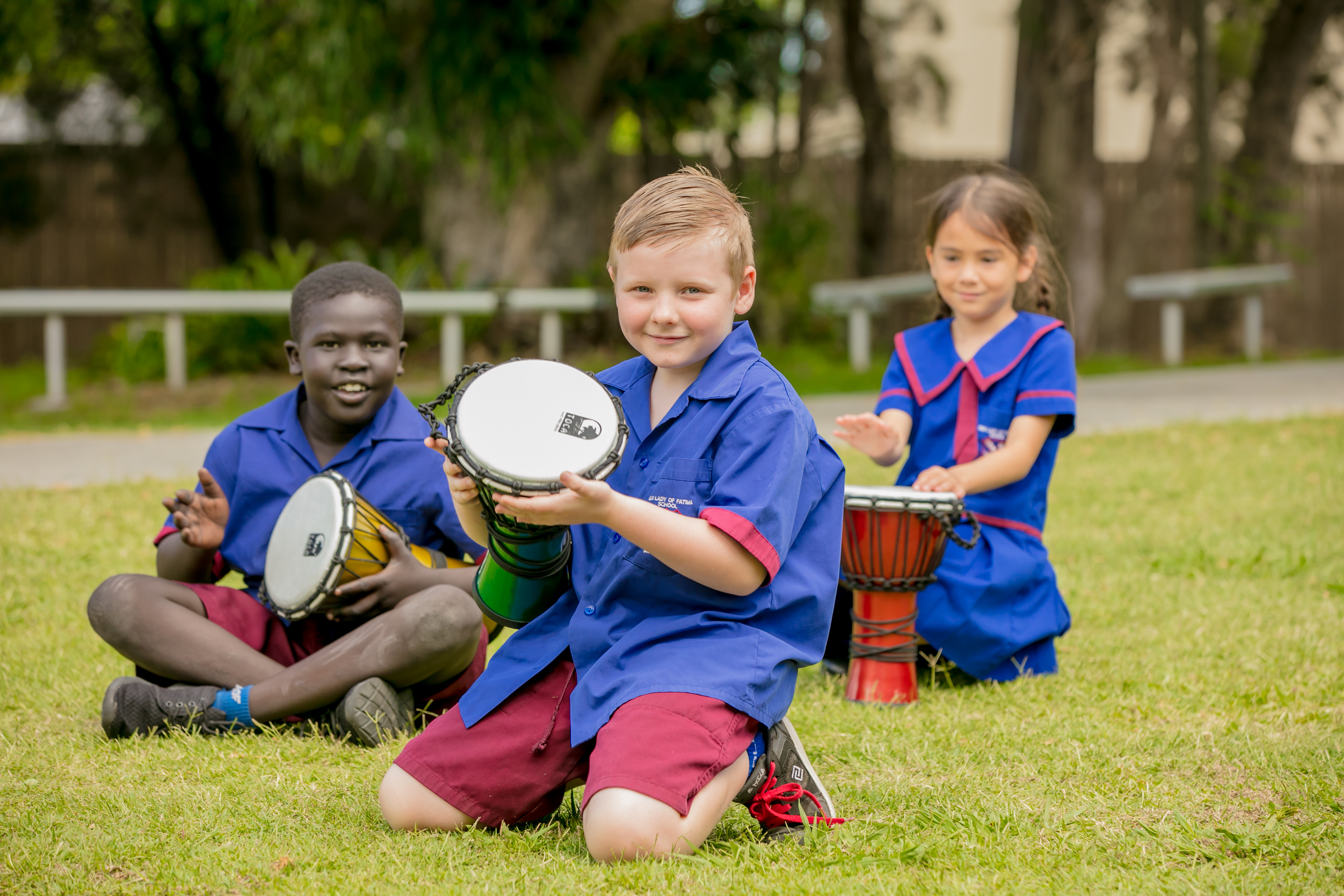 Students playing hand drums outdoors at Our Lady of Fatima Primary School Acacia Ridge promoting cultural learning collaboration and active participation